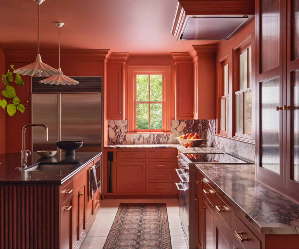 Warm terracotta kitchen featuring professionally painted walls and cabinetry and modern finishes by an interior painter in Kernersville, NC.