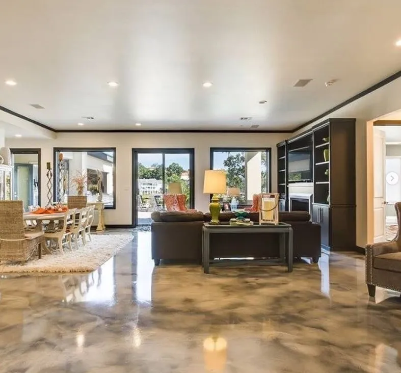 Metallic epoxy flooring with a polished concrete finish in an open-concept living space by an interior painter in Lexington, NC