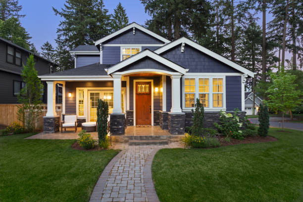 House exterior with blue-gray siding, crisp white trim and dark stone finishes by a house painter in Bermuda Run, NC.