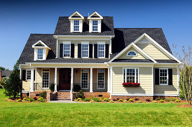 Light yellow exterior siding with white trim and brick finishes by a house painter in Bermuda Run, NC.
